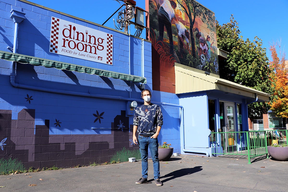 Photo of a man in front of a building