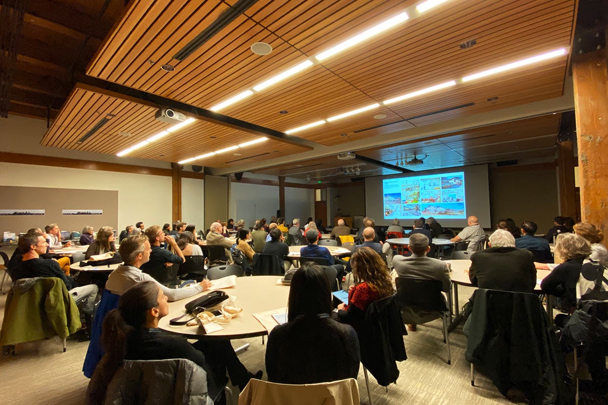 Photo of Reynolds Symposium, people in conference room