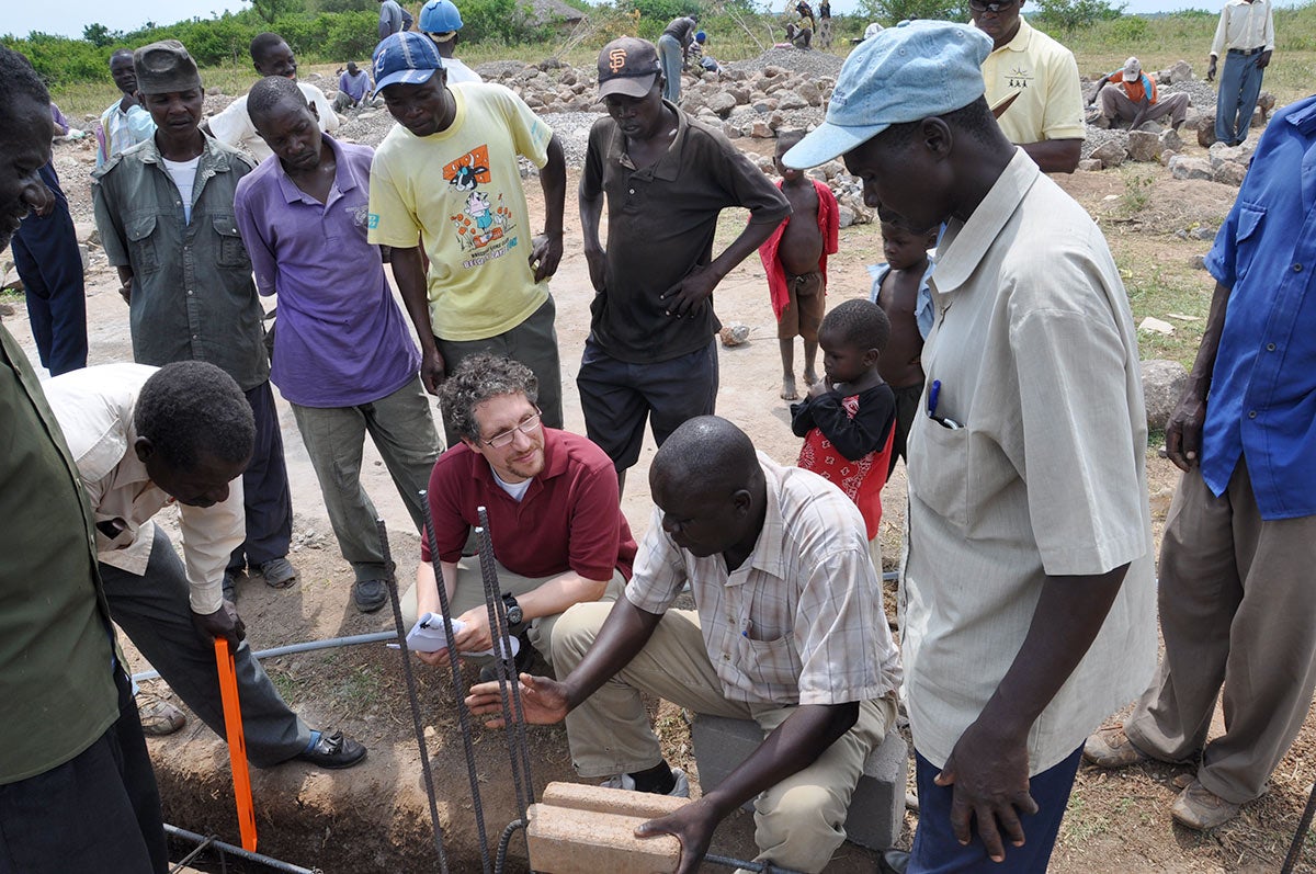 A group of people working on something outside in Tanzania