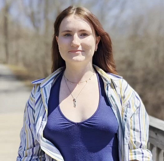 Photograph of student, Ava Galbraith, as she stands in an outdoor location. 