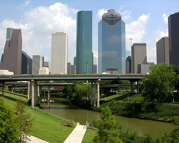 city skyline with river and highway overpass