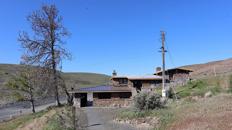 A residence near or in Ginkgo Petrified Forest State Park. Shows a multilevel house on a hill. 