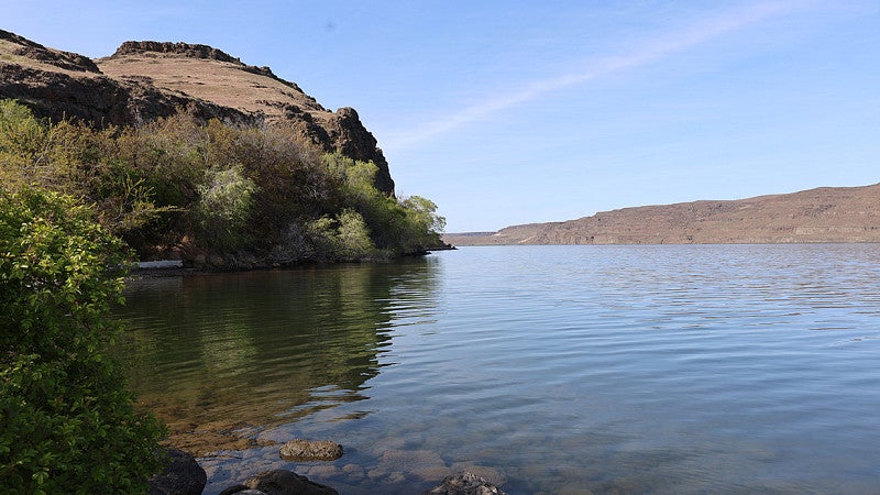 Scenic landscape with water and an elevated rock. 