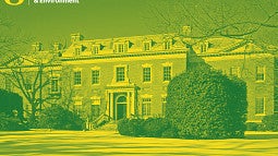 Photograph of the Dumbarton Oaks estate in Washington, D.C. Shows an old, red brick, manor style house in the snow with empty trees framing the wide shot.