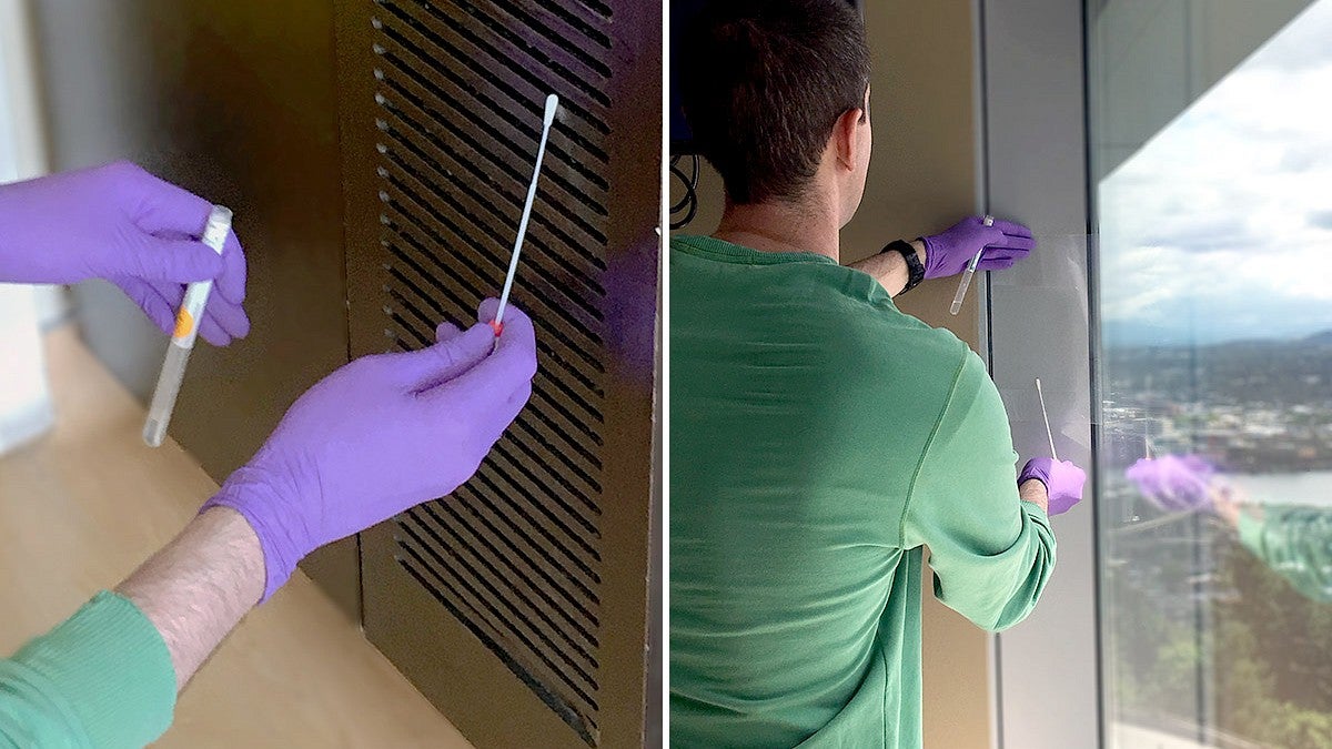 gloved hands gathering a sample on a vent with a swab