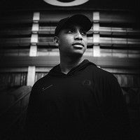Photograph of Malik Lovette in black and white. 