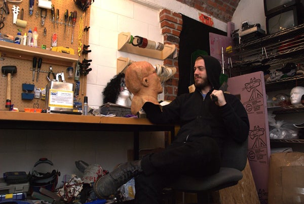 In his studio, Mike Stephen looks into the eyes of “the ‘other,’ one of many hand-crafted masks and props I use in my performance and video works. In many ways that was my Hamlet...’To be or not to be (the other), that is my question.’ “ Photograph by Sabina Samiee. Mike Stephen