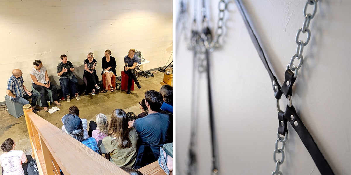 an audience listening to a panel; leather and metal artwork in gallery