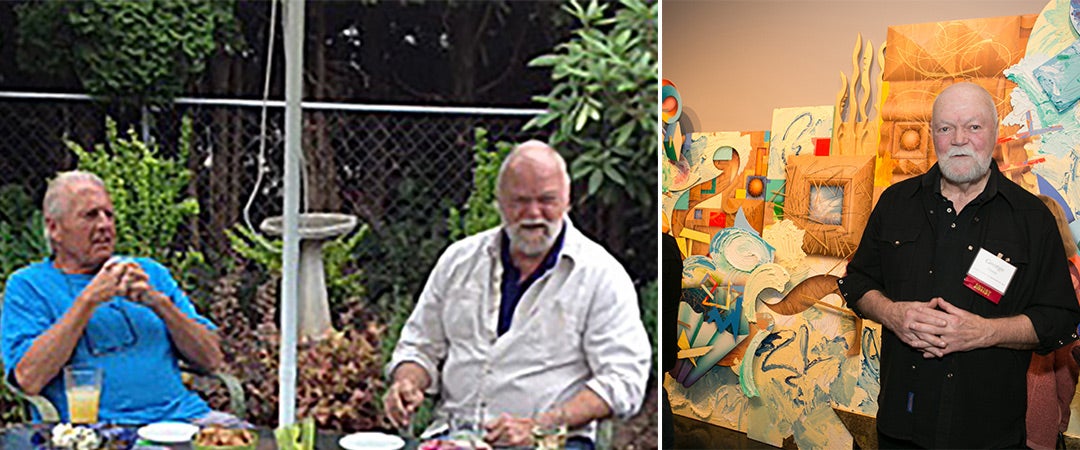 Two men sitting at a table and George Green standing in front of his painting