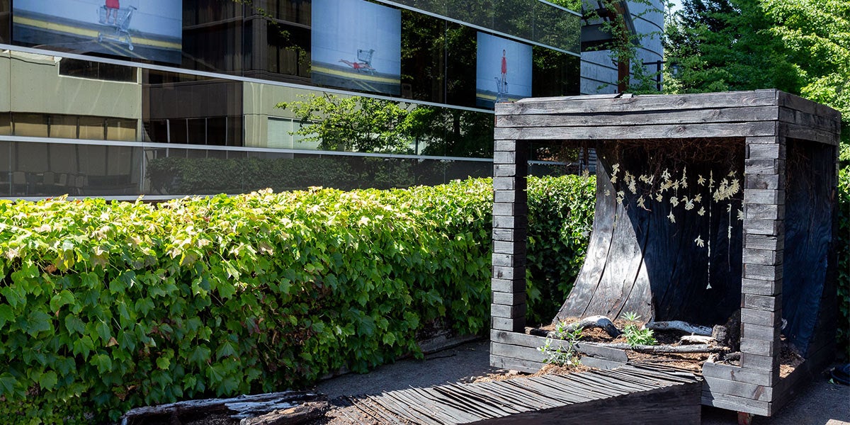 Wooden cube displaying art outside