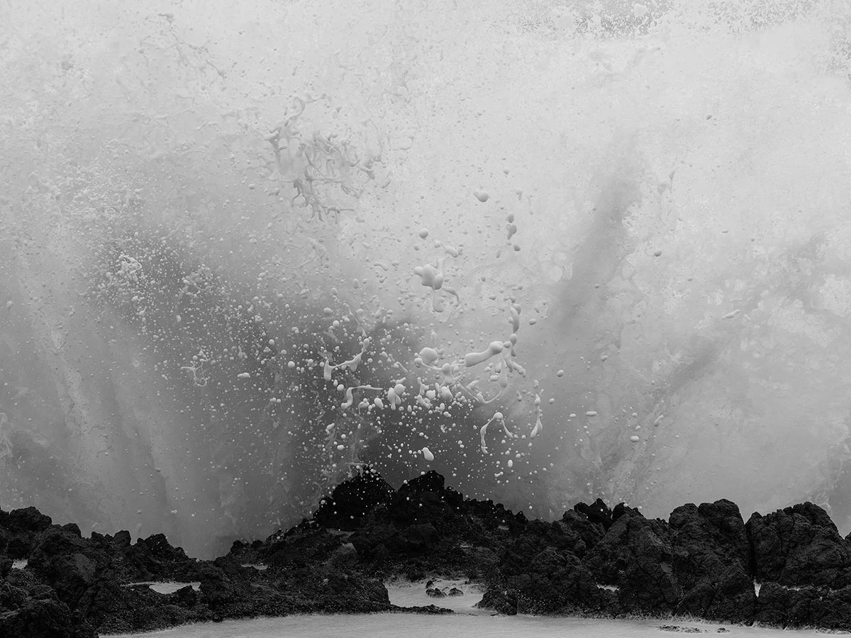 Black and white photo of a wave crashing