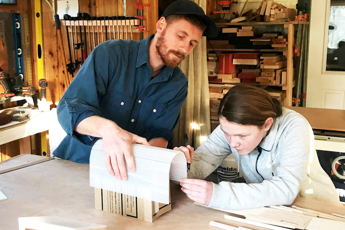 photo of a mentor and student working at a draft table