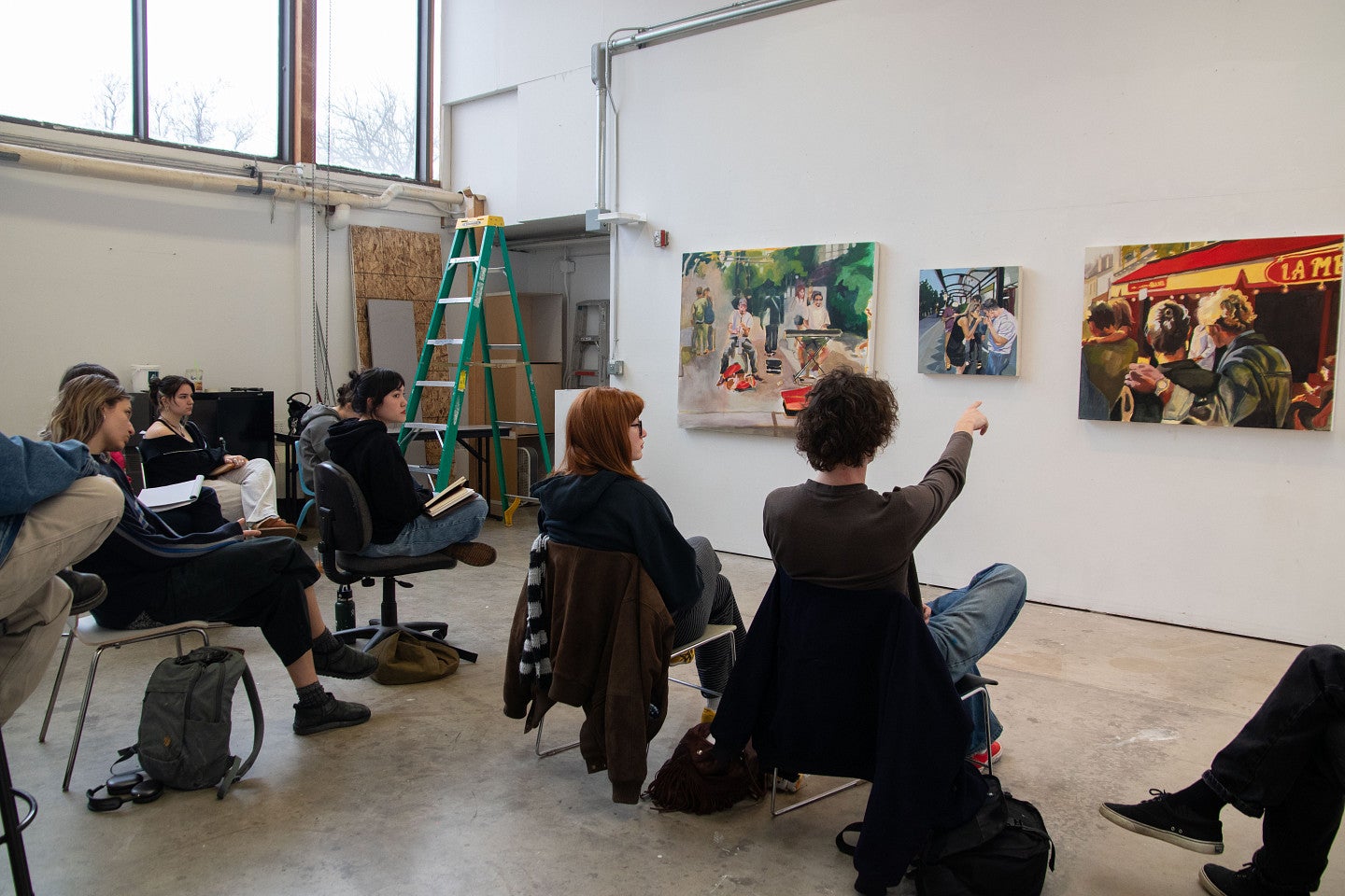 Students participate in a critique during class. Decorative.