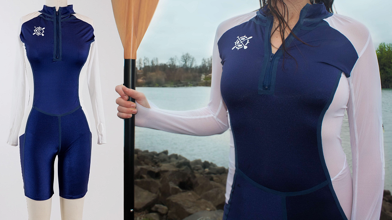 a woman holding an oar. She is wearing a navy, nylone/spandex body suit with white mesh over her arms and down her sides.