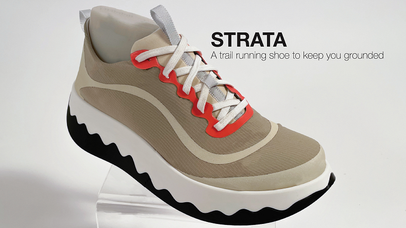 a tan, boot-like sneaker with orange eyelets, and a thick, bisected, wavy sole. The upper half of the sole is white, and the bottom is black.