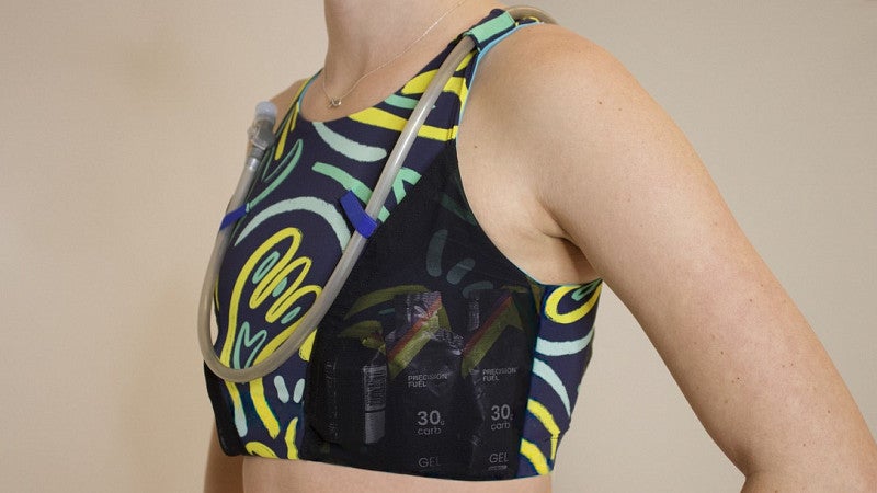 a sports bra with a multi-colored pattern, large mesh pockets, and a drinking tube to drink directly from the bra.