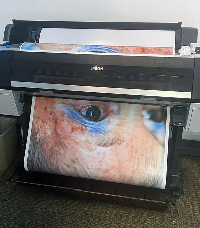 large format printer with close up photo of a face 
