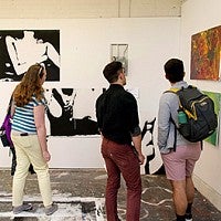 people look at artwork at the 2016 Spring Storm exhibit