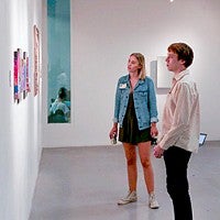 students examine artwork