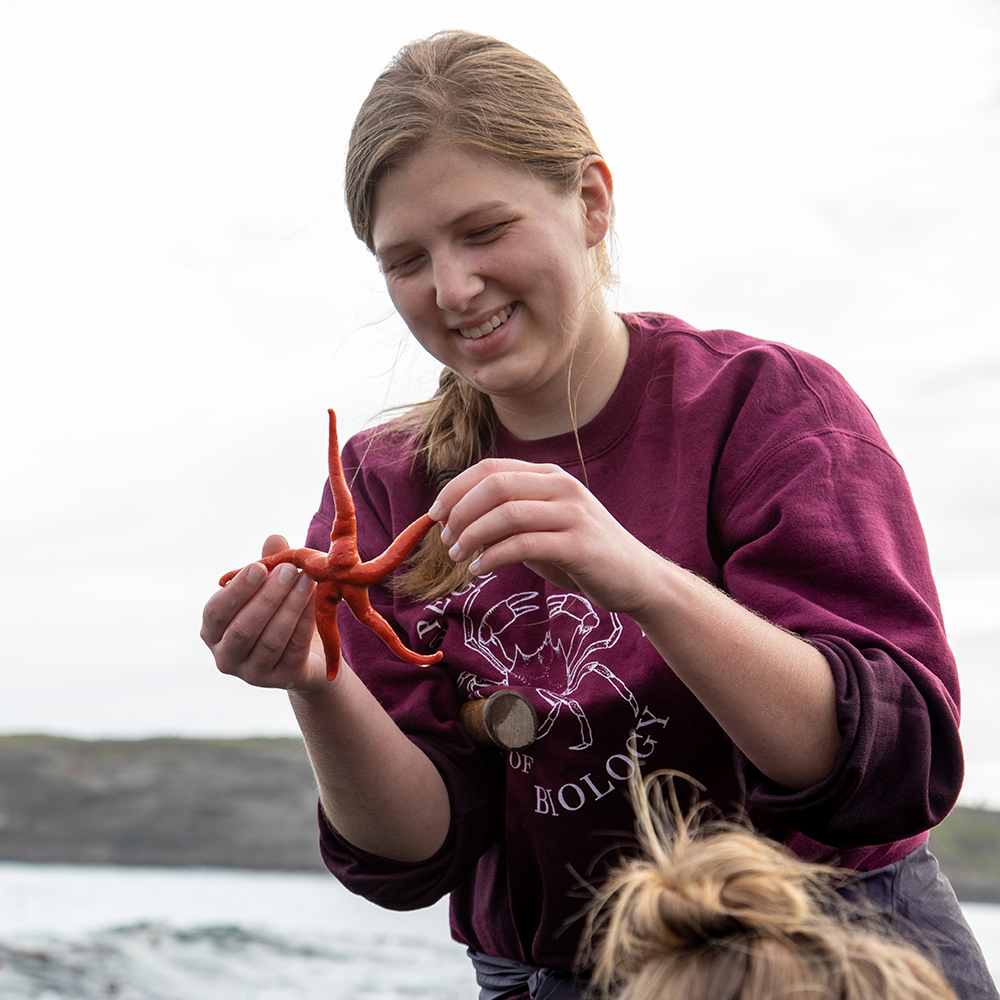 A student holding a starfish