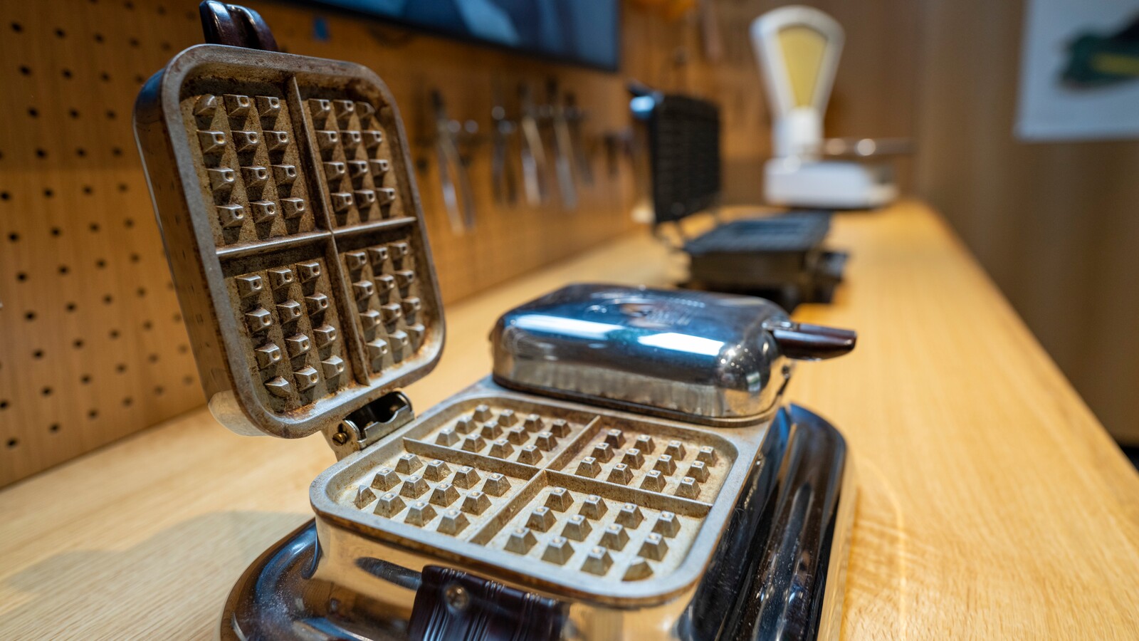 Vintage waffle irons are displayed inside Hayward Hall.