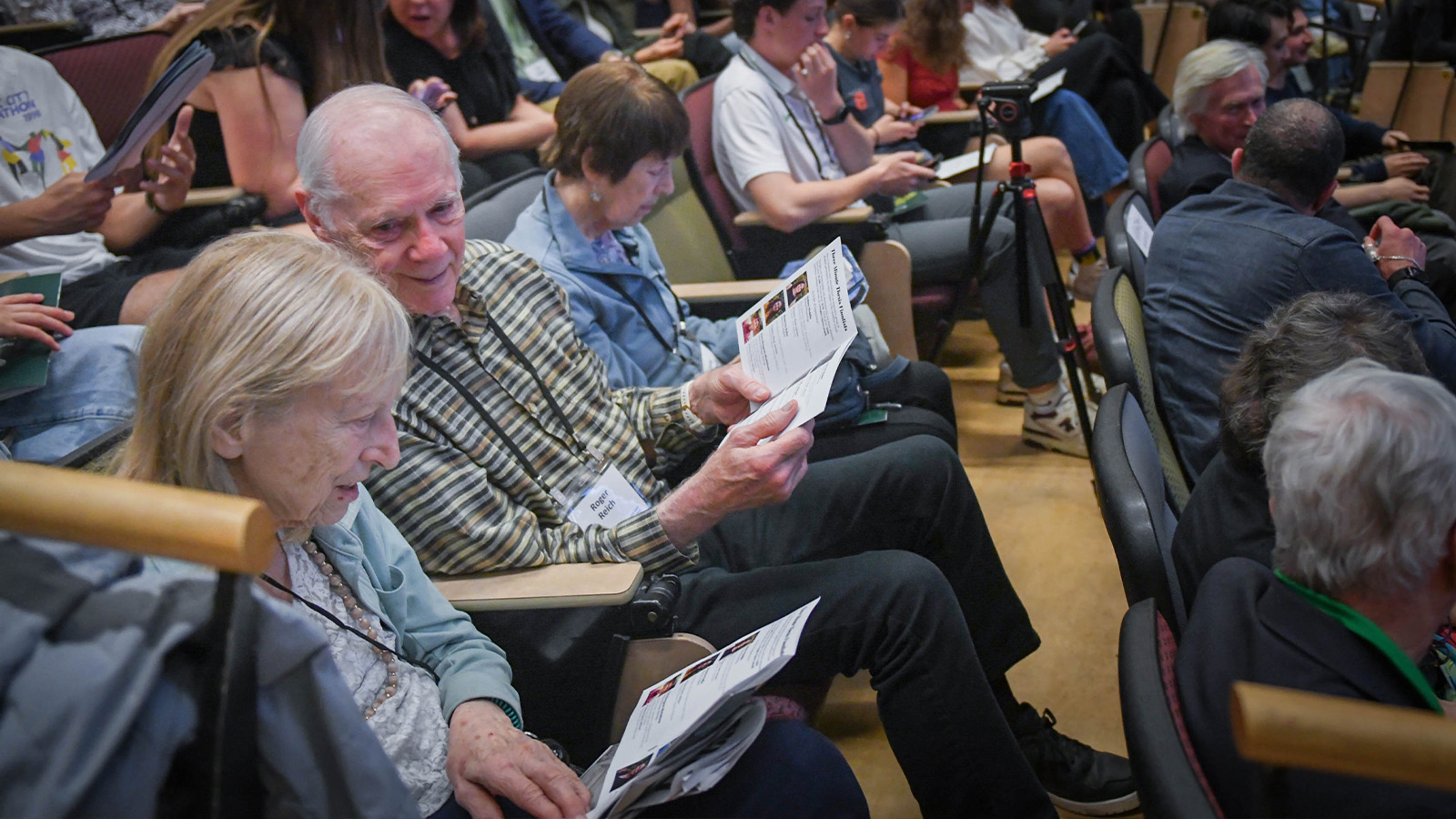 Senior citizens attending a Three Minute Thesis Competition presentation
