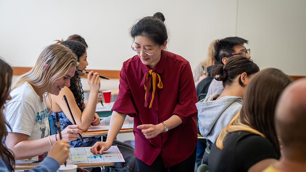 An instructor pointing to a paper in front of a student