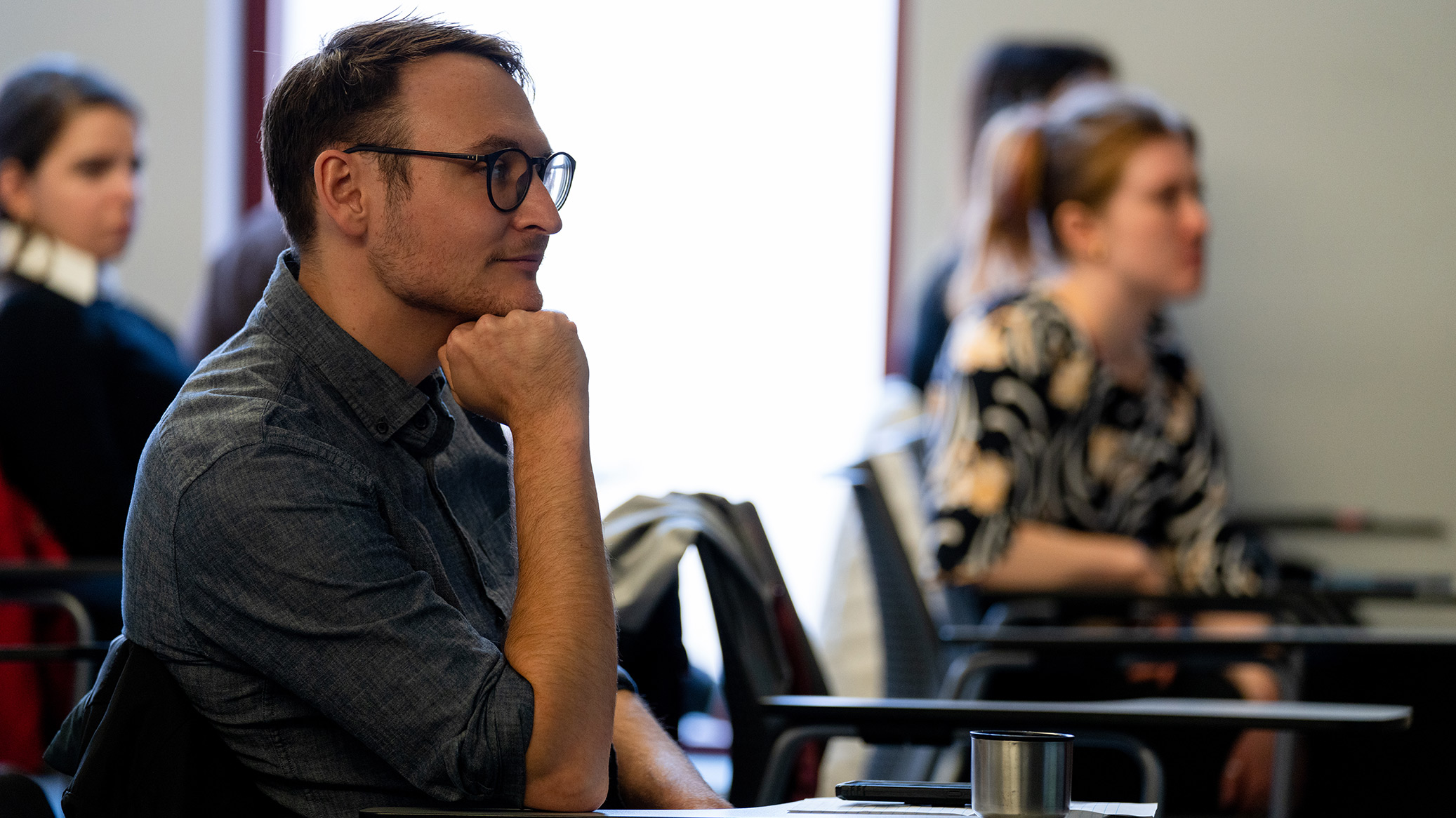 A law student listening in a classroom