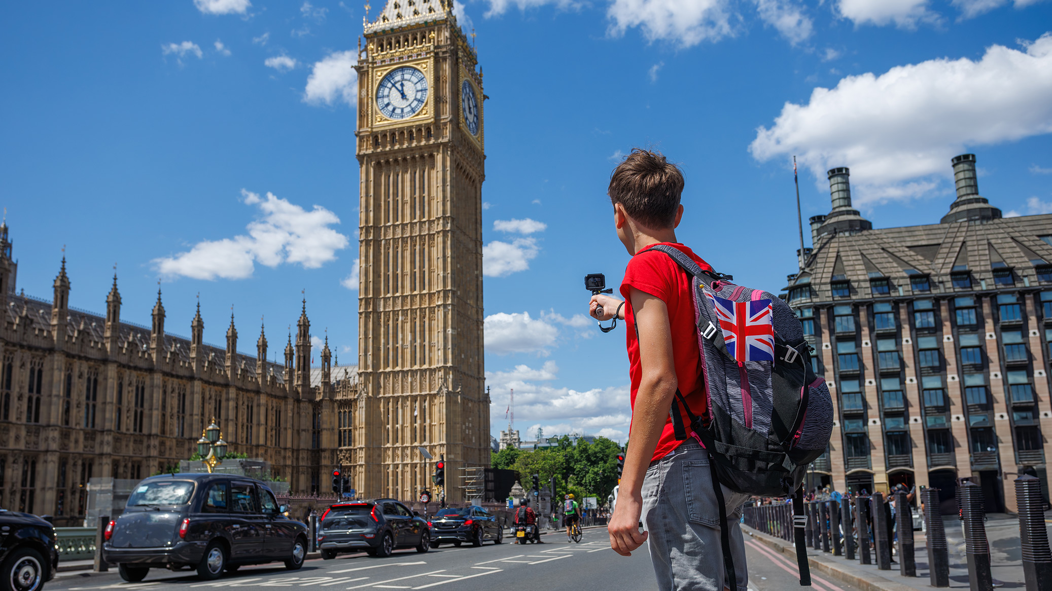 A student photographs Big Ben from a London street.