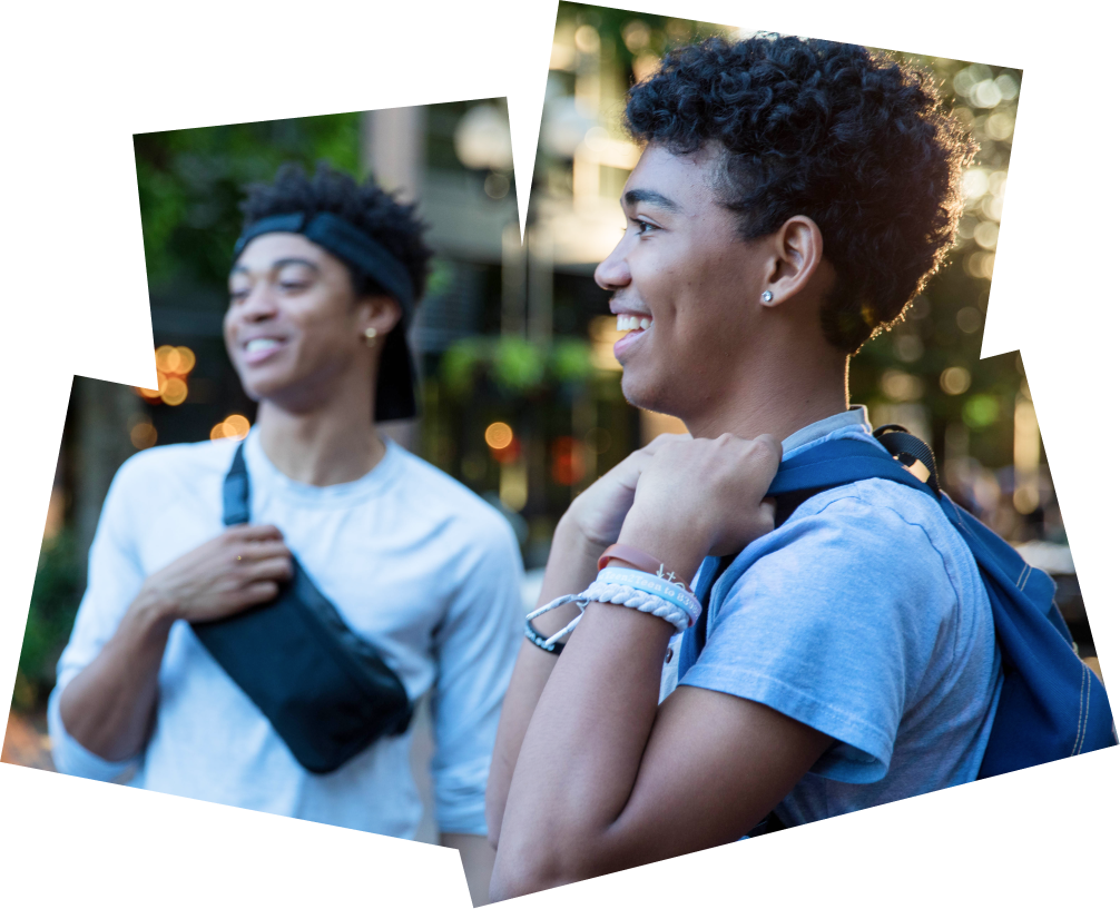 Two smiling students walking on the UO campus