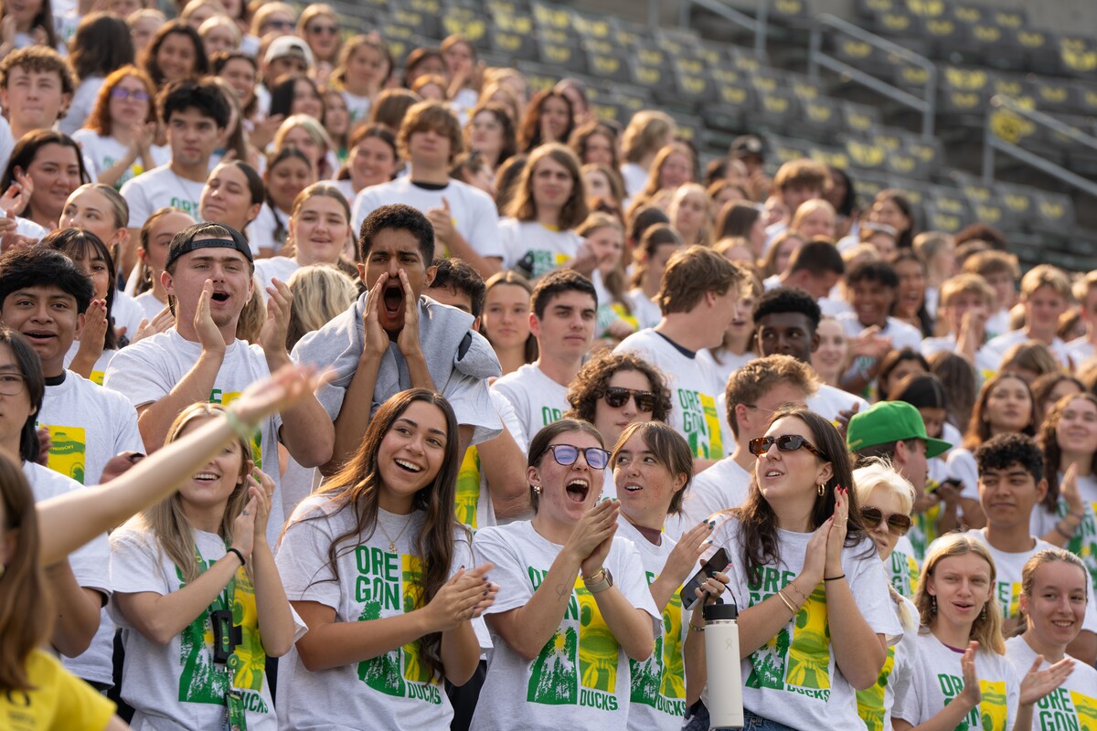 New students cheer together in the Autzen Stadium stands.