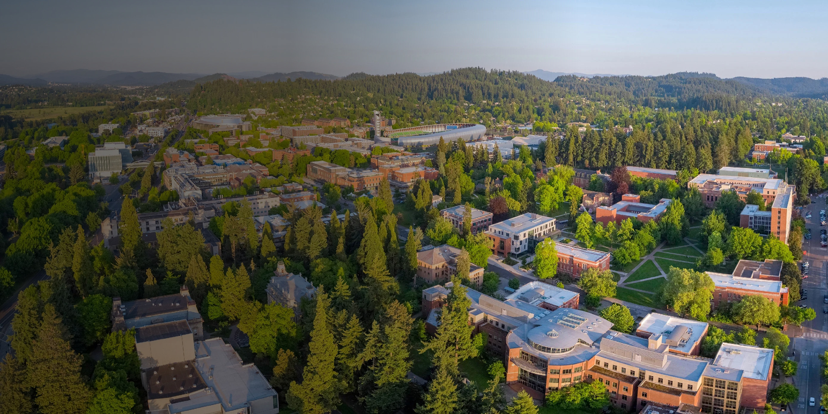 Aerial view of the University of Oregon campus in late afternoon light.
