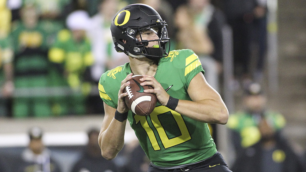 Justin Herbert getting ready to throw a football pass