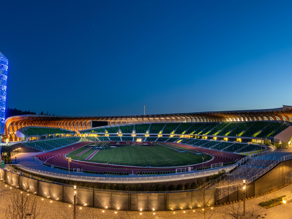 The illuminated Hayward Field track fills an evening aerial view.