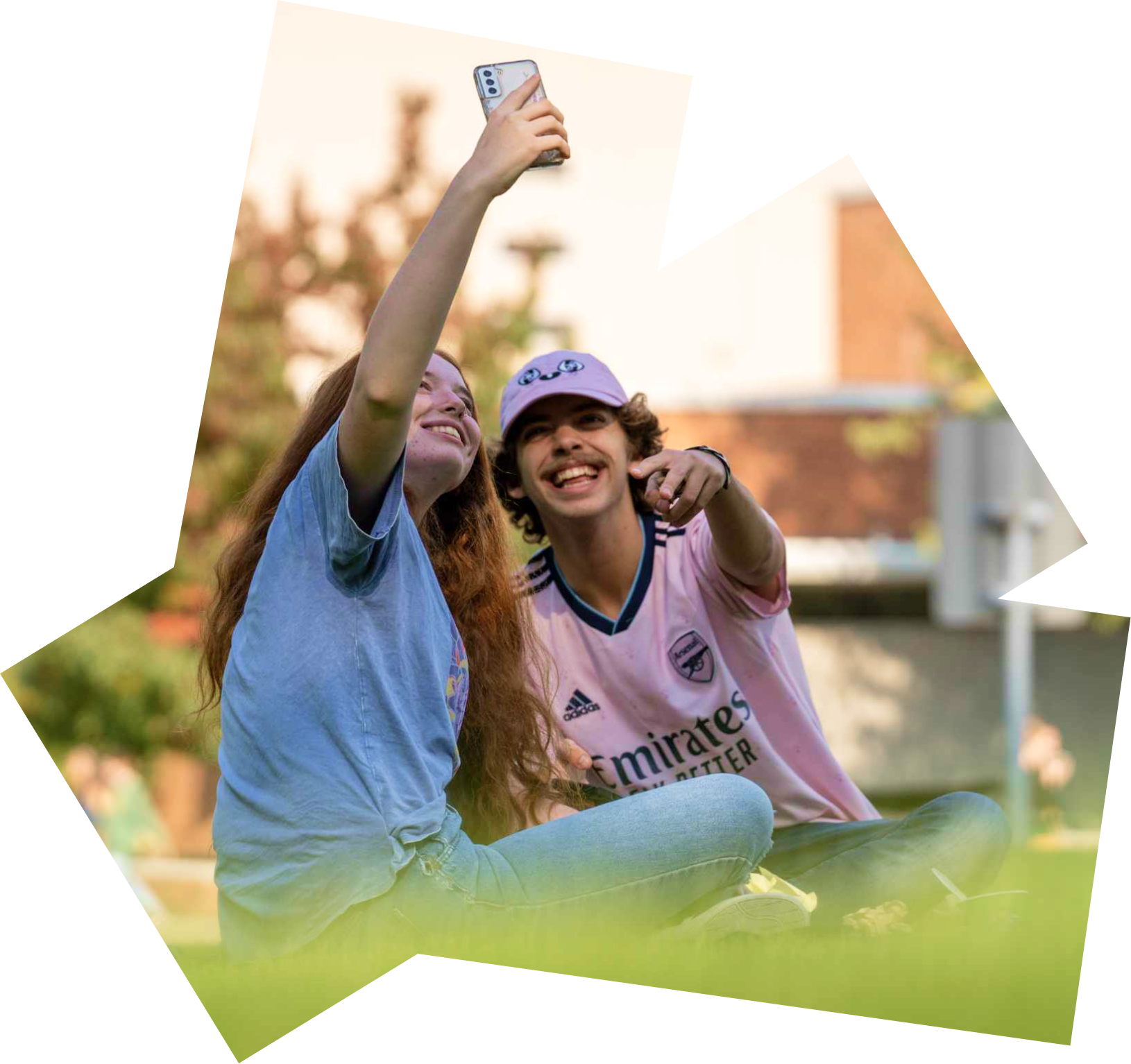 Two students take a selfie outdoors.