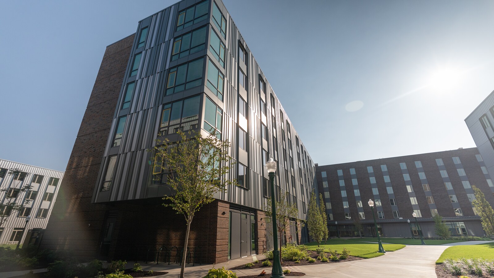 A University of Oregon residence hall exterior gleams in the sunlight.