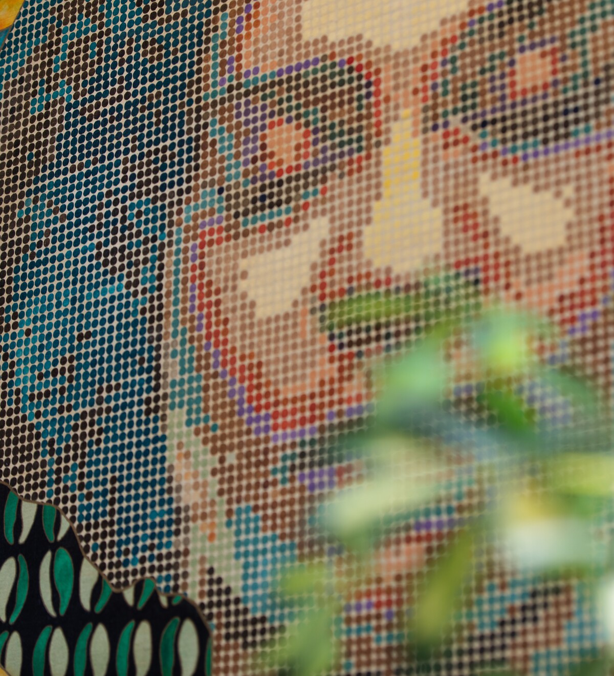 A projected portrait appears across a colorful textured surface.