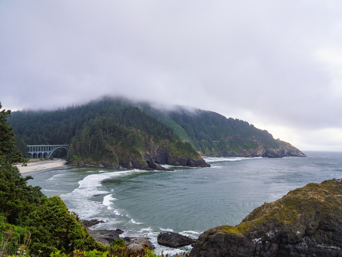 A misty headland curves along the Oregon coast.