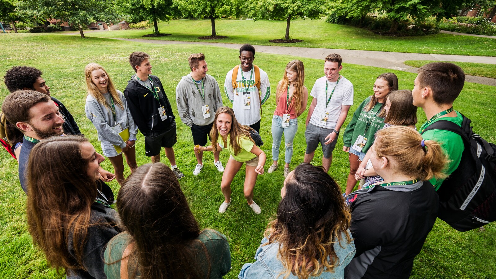 Students gather in a circle during a campus welcome event.