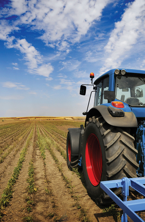 A tractor plowing the fields