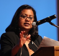 A woman speaks at a podium