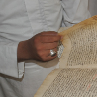 A man turns the pages of an old text