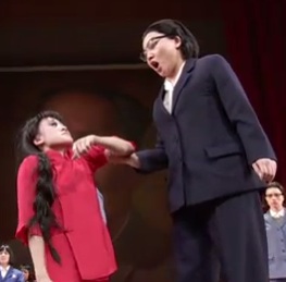 A man and a woman acting on stage