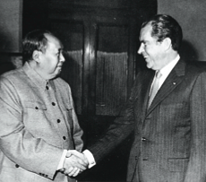 A man in a uniform shaking hands with a man in a suit