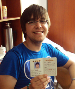 A young man holding his passport