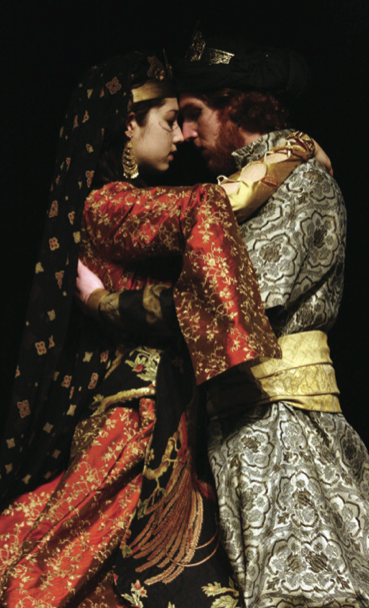 A man and woman in costume embrace