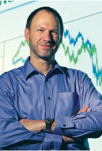A man standing in front of a presentation graph
