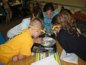 Young children examining things in a group