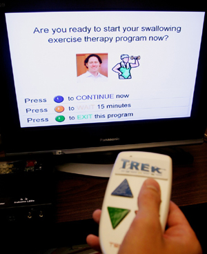 A person holding a television remote and clicking options on a TV