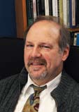 A man in a sweater and tie